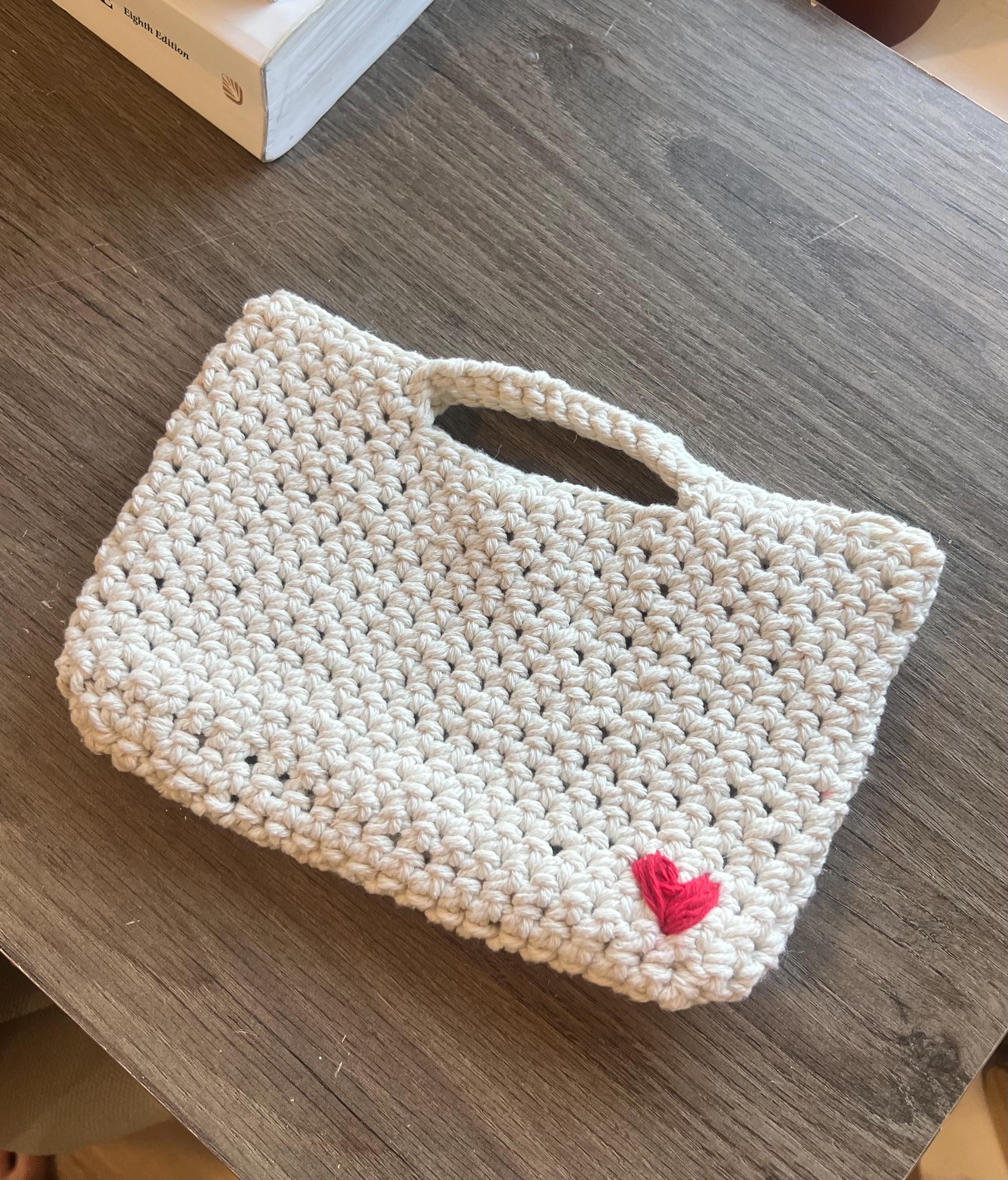 Beginner crochet mini purse PDF pattern preview showing the heart appliqué placement on the front panel