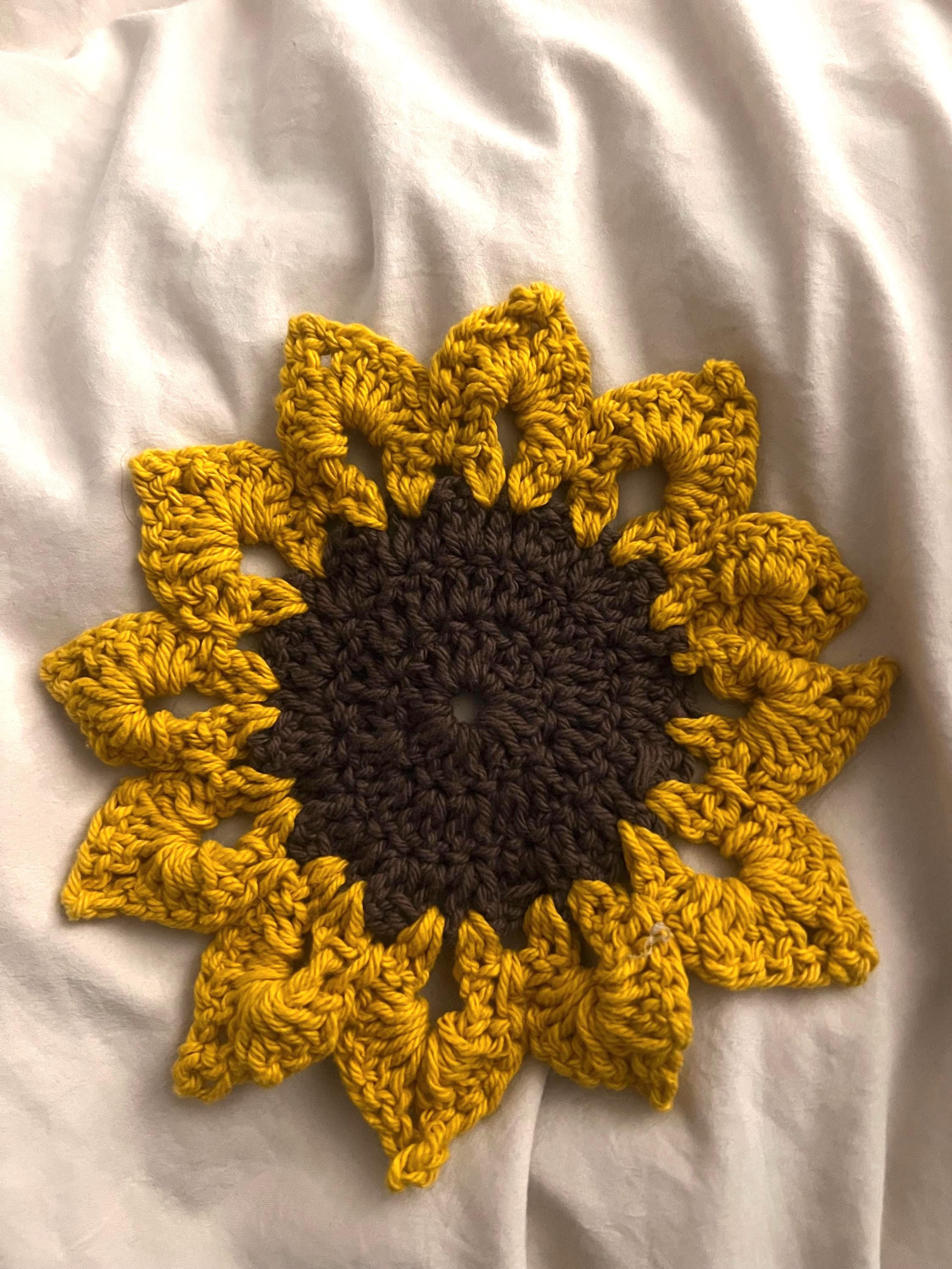 Crochet sunflower coaster styled on a kitchen counter as summer home decor and surface protection