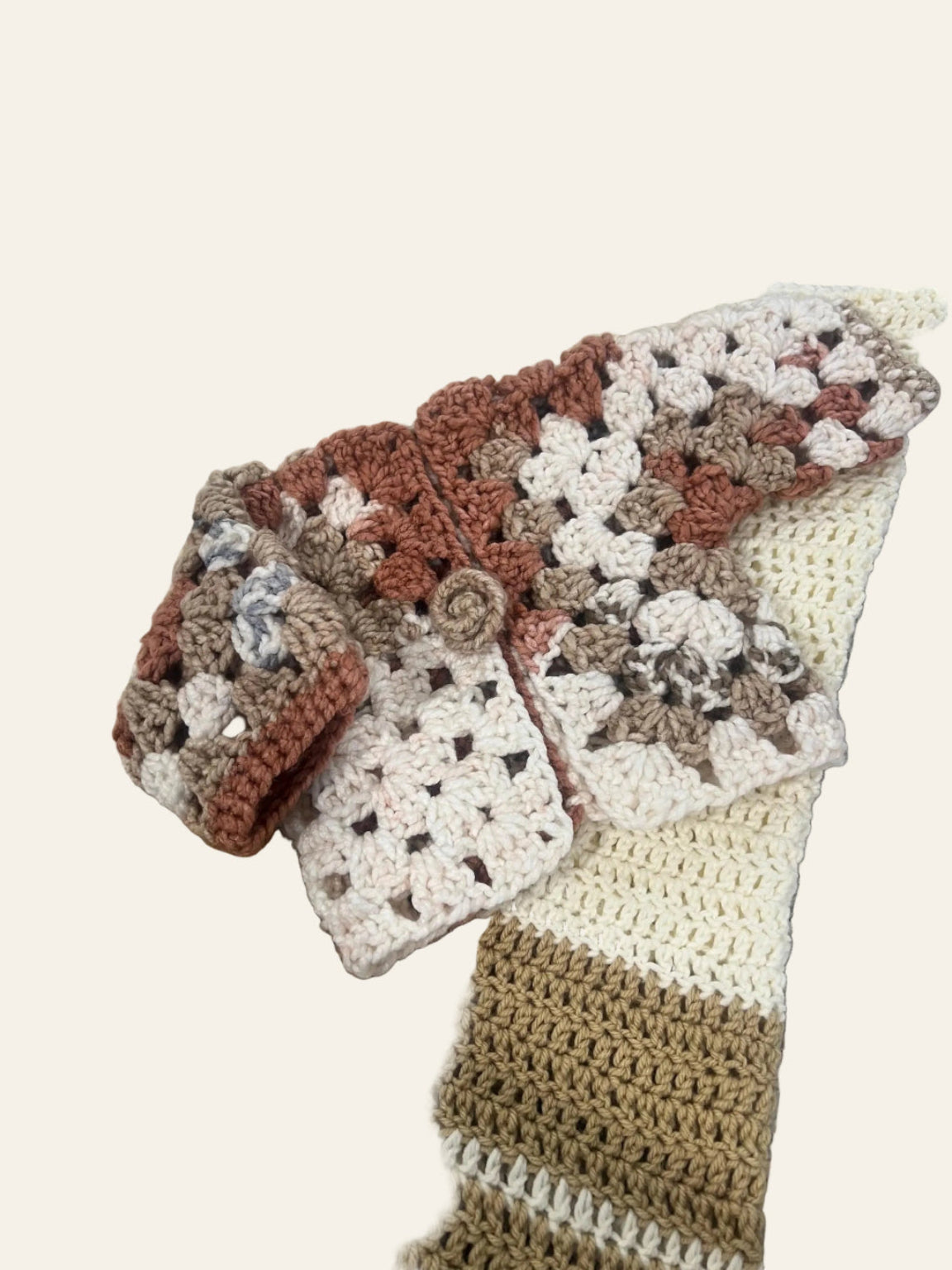 Baby crochet cardigan pattern — handmade hexagon sweater for newborn to toddler styled flat against a soft neutral backdrop