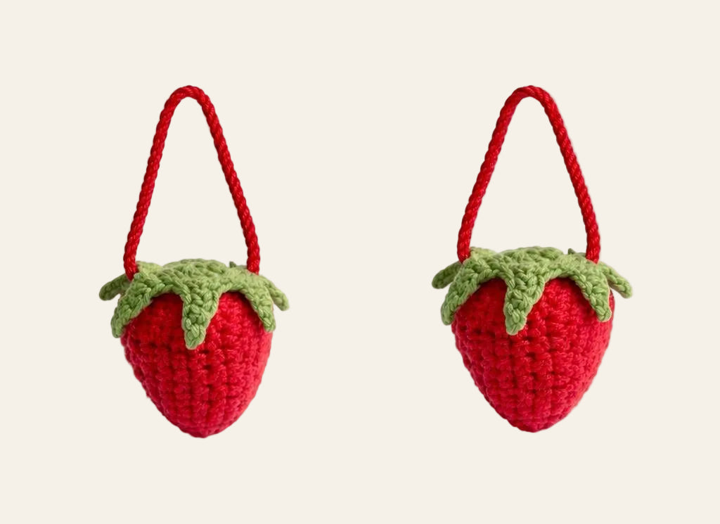 Mini crochet strawberry zipper pull on a backpack zipper — cottagecore amigurumi accessory pattern