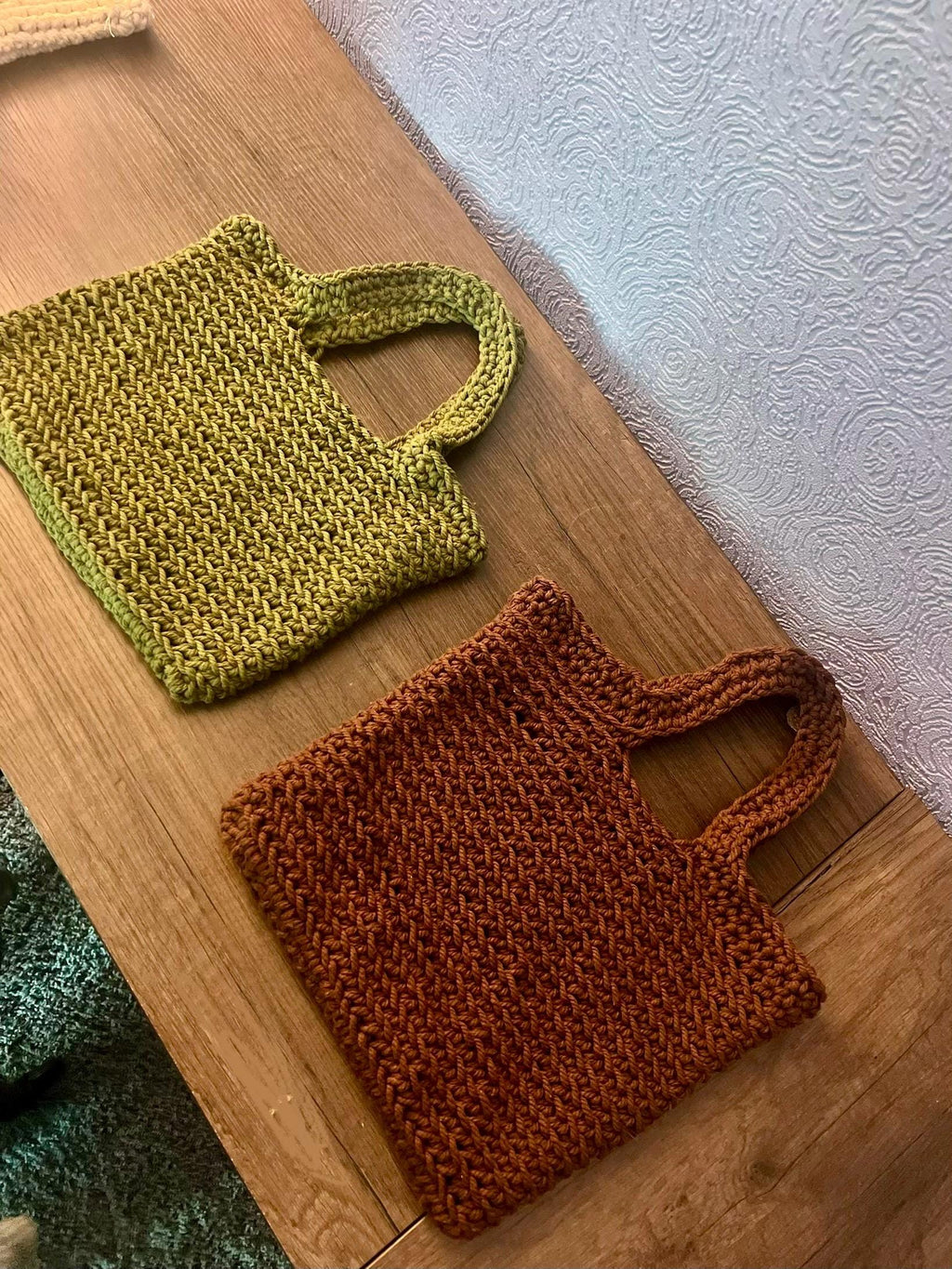 Reusable crochet grocery bag carried by hand, showing the eco-friendly, washable cotton fabric and finished size
