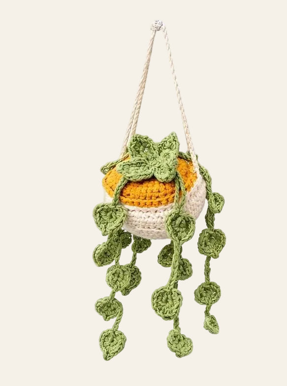 Faux crochet money plant beside real houseplants on a desk to show realistic shape and trailing length