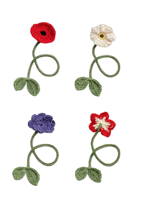 Crochet flower bookmark pattern bundle — finished red poppy, white daisy, five-petal flower and periwinkle bookmarks on a book