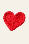 Beginner crochet heart pattern — small handmade red heart appliqué styled on a light neutral surface for Valentine's Day