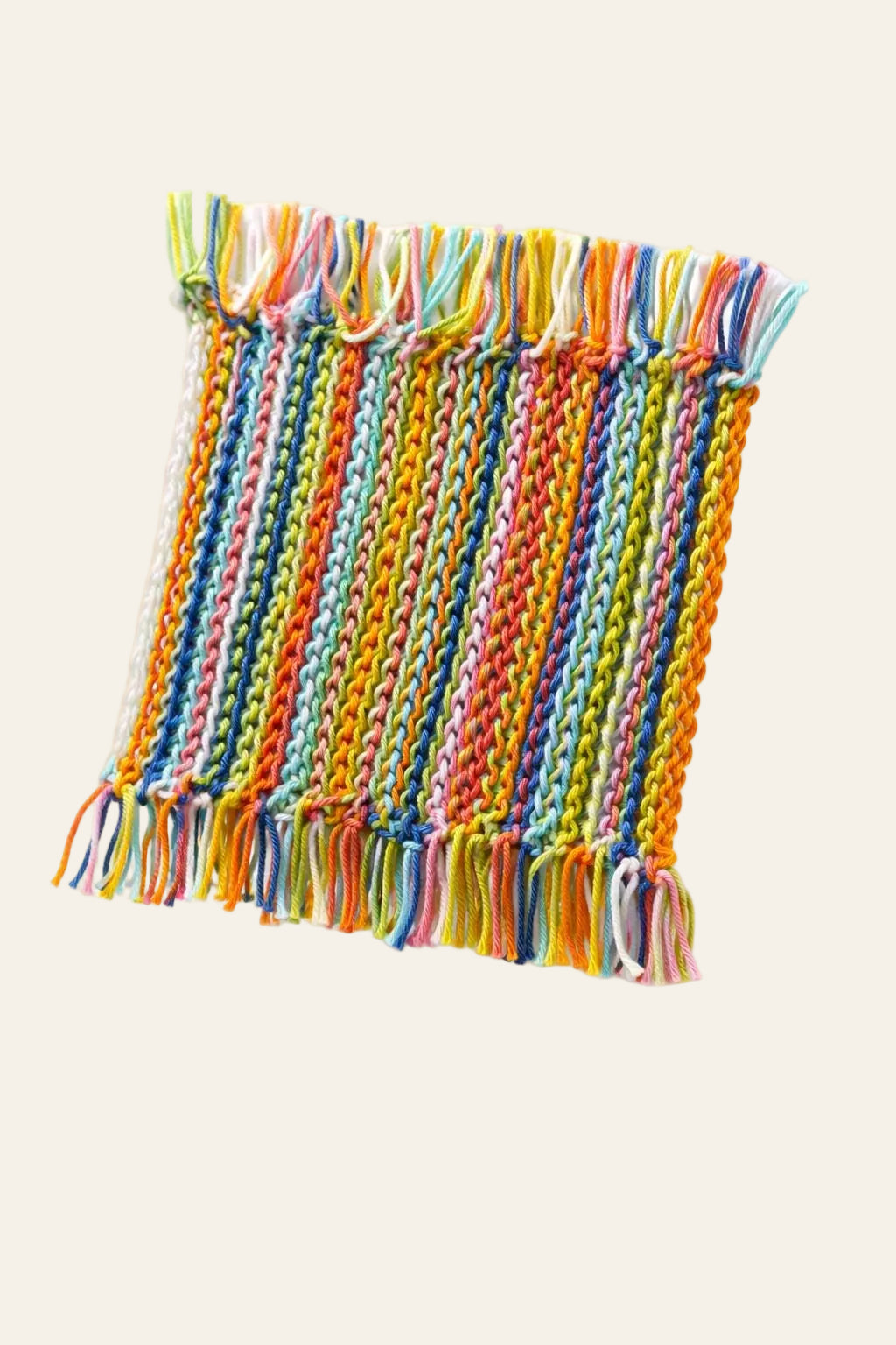 Scrap yarn crochet coaster pattern — colorful handmade coaster made from leftover yarn under a ceramic mug